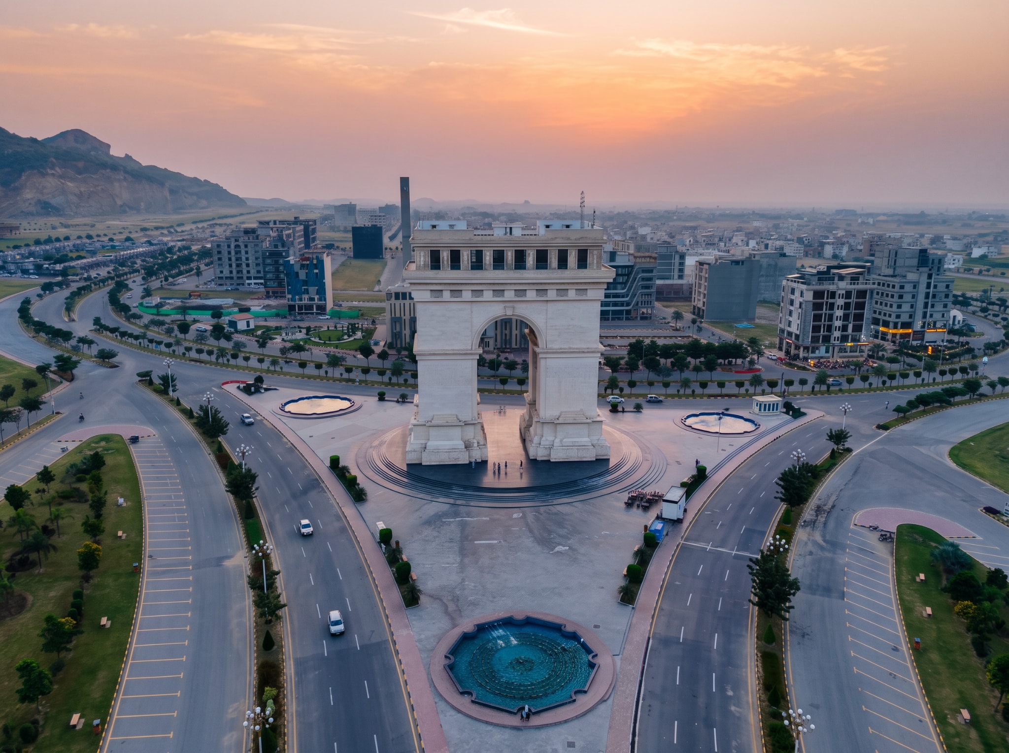 Faisal Hills landmark arch and surrounding city at sunset